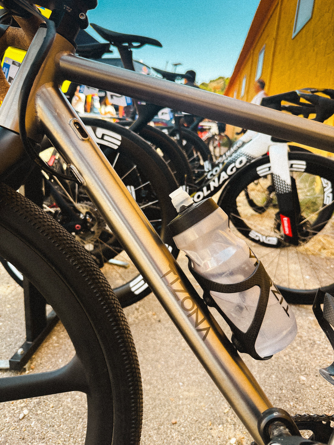 Tizona titanium frame parked among WorldTour team bikes at the 2026 Vuelta a Burgos